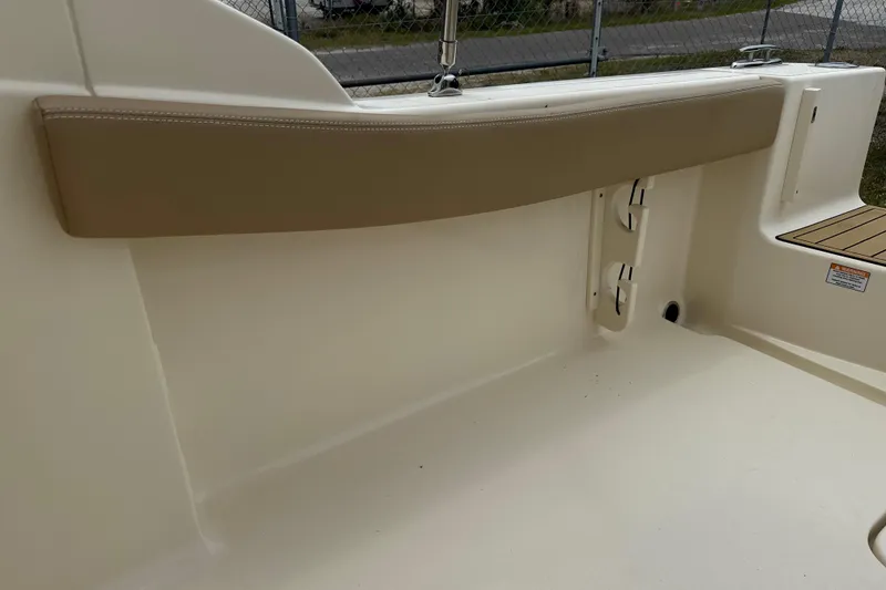 Slide: The Image of Interior view of 2023 Scout 215 Dorado boat, featuring beige seating and clean design. - 14