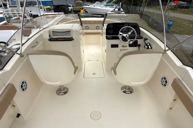 Slide: The Image of 2023 Scout 215 Dorado boat interior with dual seats and steering console. - 16