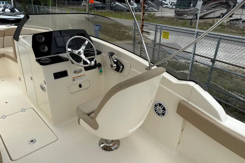 Slide: The Image of 2023 Scout 215 Dorado boat interior with steering wheel and control panel. - 17