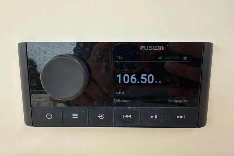 Slide: The Image of Fusion marine stereo display on 2023 Scout 215 Dorado, showing FM 106.50 MHz. - 25