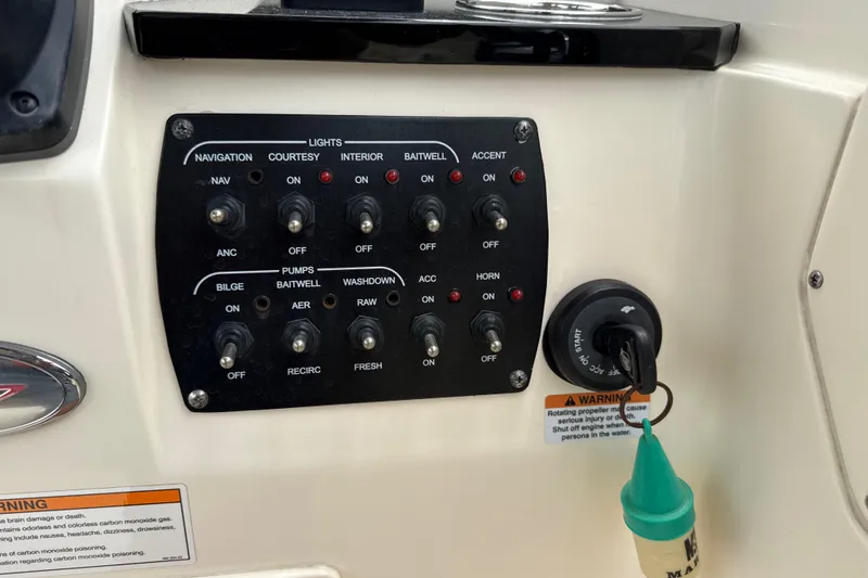 Slide: The Image of Control panel of 2023 Scout 215 Dorado boat with switches and ignition key. - 28