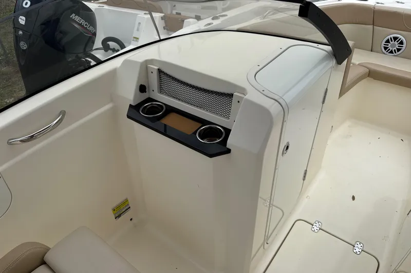 Slide: The Image of 2023 Scout 215 Dorado boat interior with cup holders and storage compartment. - 29