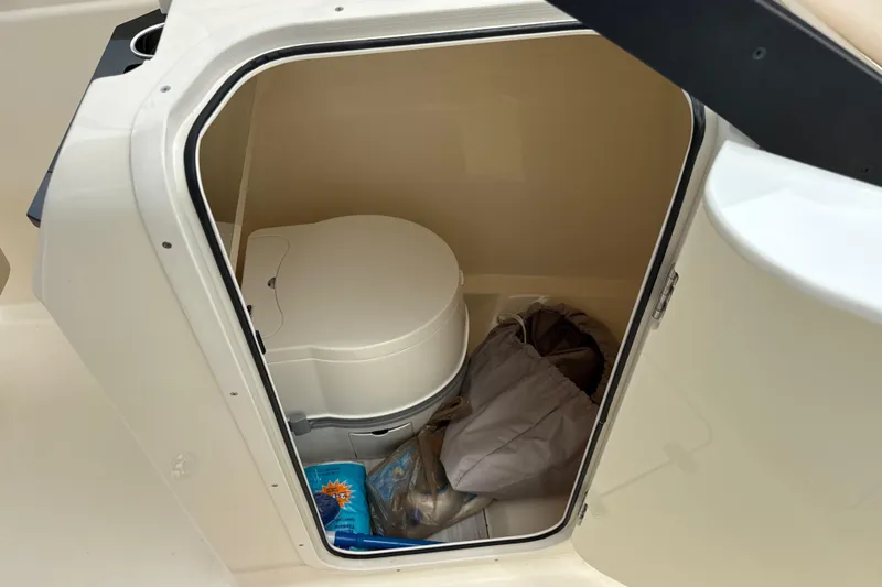 Slide: The Image of 2023 Scout 215 Dorado boat interior storage with portable toilet and supplies. - 30