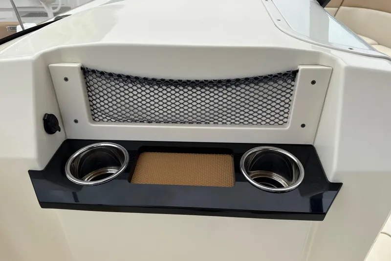 Slide: The Image of 2023 Scout 215 Dorado boat console with cup holders and storage net. - 31