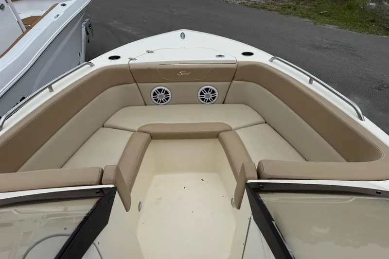 Slide: The Image of 2023 Scout 215 Dorado boat interior with beige seating and speaker system. - 34