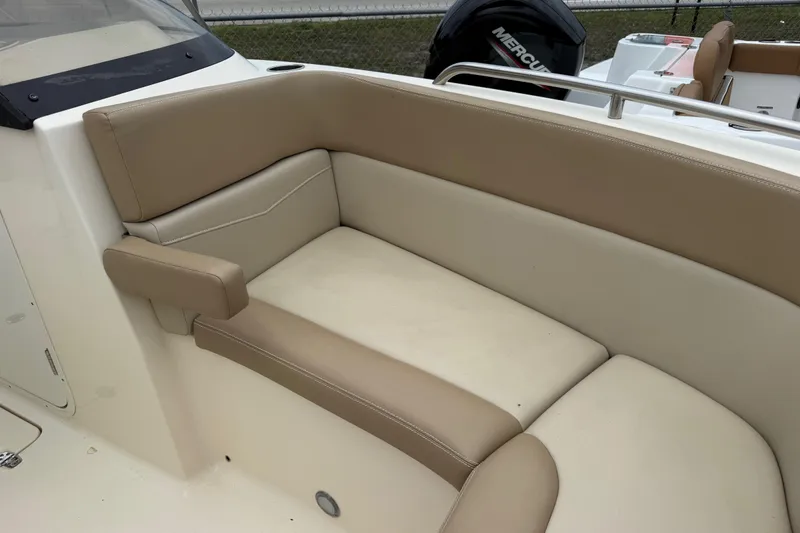 Slide: The Image of 2023 Scout 215 Dorado boat interior with beige seating and armrest. - 35