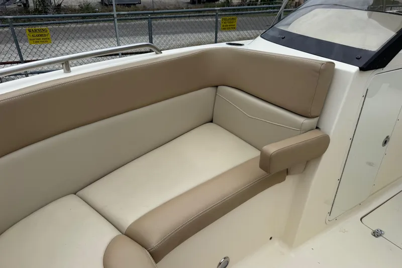 Slide: The Image of 2023 Scout 215 Dorado boat interior with beige seating and armrest. - 36