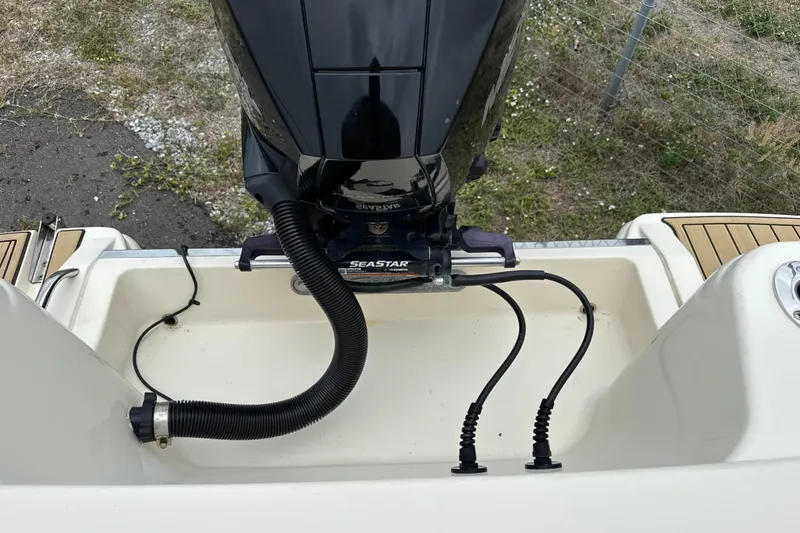 Slide: The Image of 2023 Scout 215 Dorado boat engine and deck view with cables and fittings. - 9