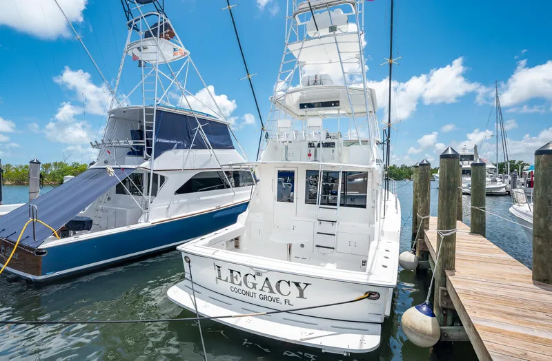 Slide: The Image of 1992 Hatteras 50 Convertible yacht docked at a marina. - 10