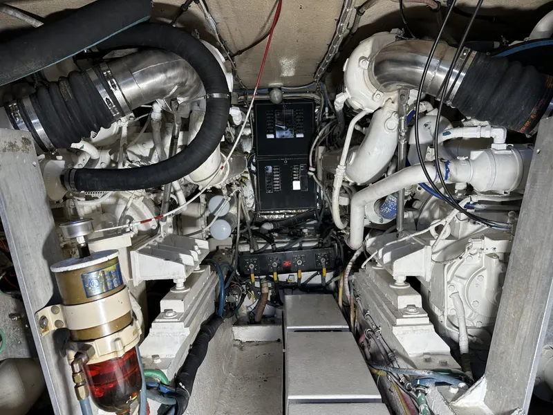 Slide: The Image of Engine room of a 1992 Hatteras 50 Convertible yacht with twin engines and control panel. - 35