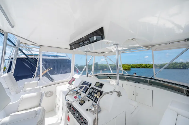 Slide: The Image of 1992 Hatteras 50 Convertible yacht helm station with navigation equipment and scenic water view. - 6