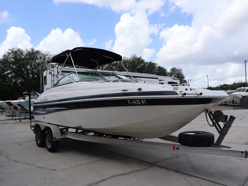 Slide: The Image of 2008 NauticStar 210 DC boat on trailer under blue sky. - 5