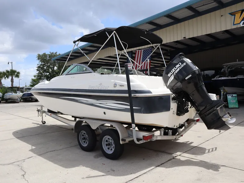 Slide: The Image of 2008 NauticStar 210 DC boat on trailer with Suzuki engine. - 9