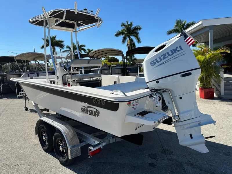 Slide: The Image of 2025 Carolina Skiff Sea Skiff 218 EV with Suzuki outboard motor on trailer. - 10