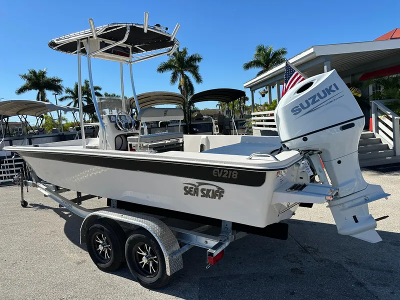 Slide: The Image of 2025 Carolina Skiff Sea Skiff 218 EV boat with Suzuki engine on trailer. - 11