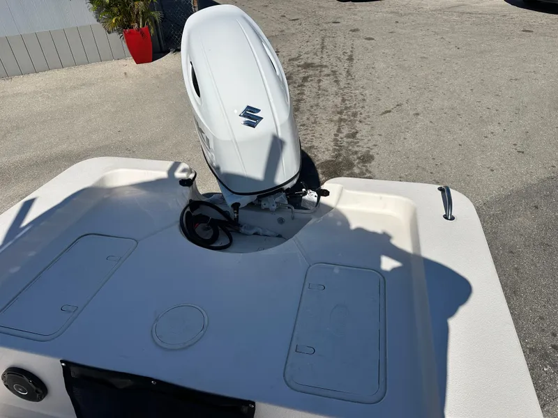 Slide: The Image of 2025 Carolina Skiff Sea Skiff 218 EV with Suzuki outboard motor, rear deck view. - 13