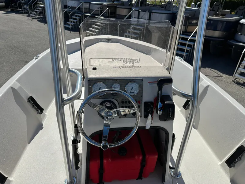 Slide: The Image of 2025 Carolina Skiff Sea Skiff 218 EV boat console with steering wheel and controls. - 14