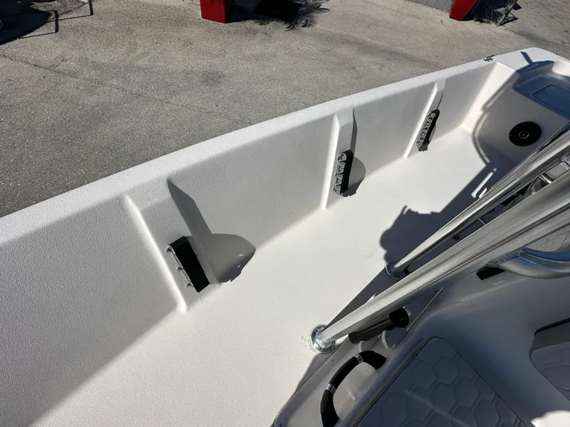 Slide: The Image of 2025 Carolina Skiff Sea Skiff 218 EV boat interior with rod holders and sleek design. - 17