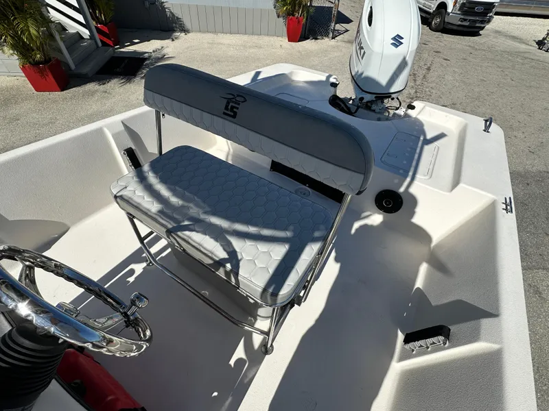 Slide: The Image of 2025 Carolina Skiff Sea Skiff 218 EV boat interior with seating and motor. - 21