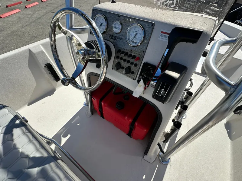 Slide: The Image of 2025 Carolina Skiff Sea Skiff 218 EV boat console with steering wheel and controls. - 22