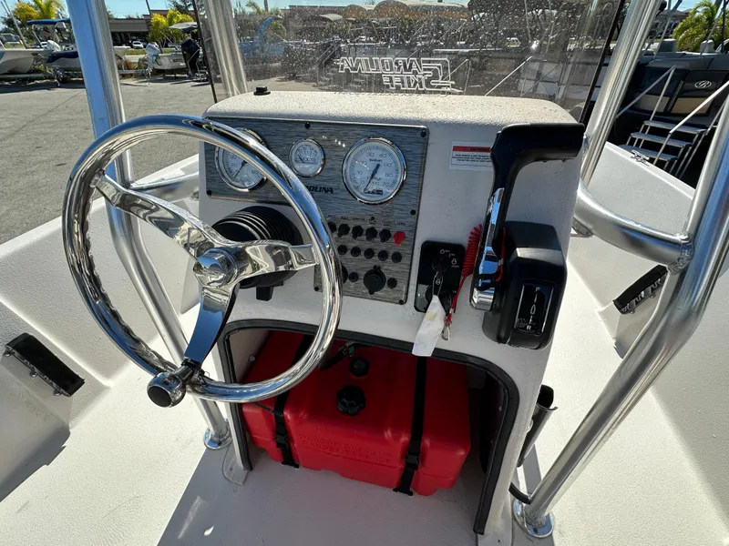 Slide: The Image of 2025 Carolina Skiff Sea Skiff 218 EV boat console with steering wheel and gauges. - 23