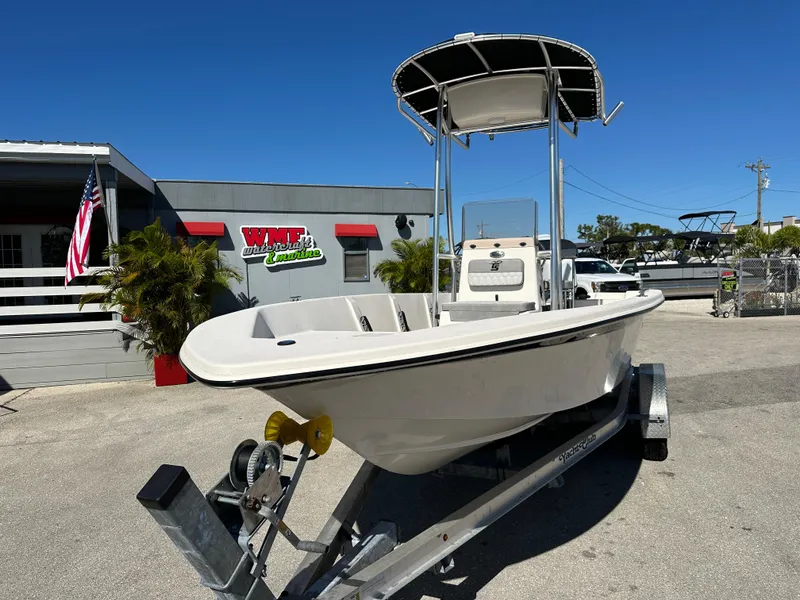Slide: The Image of 2025 Carolina Skiff Sea Skiff 218 EV on trailer, parked outside dealership. - 3