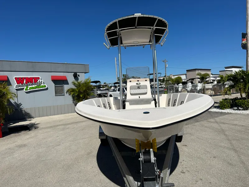 Slide: The Image of 2025 Carolina Skiff Sea Skiff 218 EV boat on trailer, outdoor dealership display. - 4