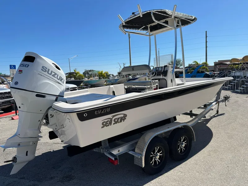 Slide: The Image of 2025 Carolina Skiff Sea Skiff 218 EV boat with Suzuki outboard motor on trailer. - 7