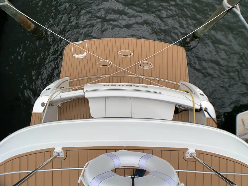 Slide: The Image of Top view of 2006 Carver 56 Voyager yacht docked, showing teak deck and swim platform. - 13