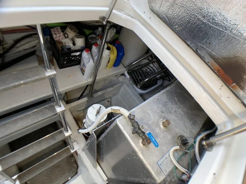 Slide: The Image of 2006 Carver 56 Voyager engine room with storage and maintenance supplies. - 27