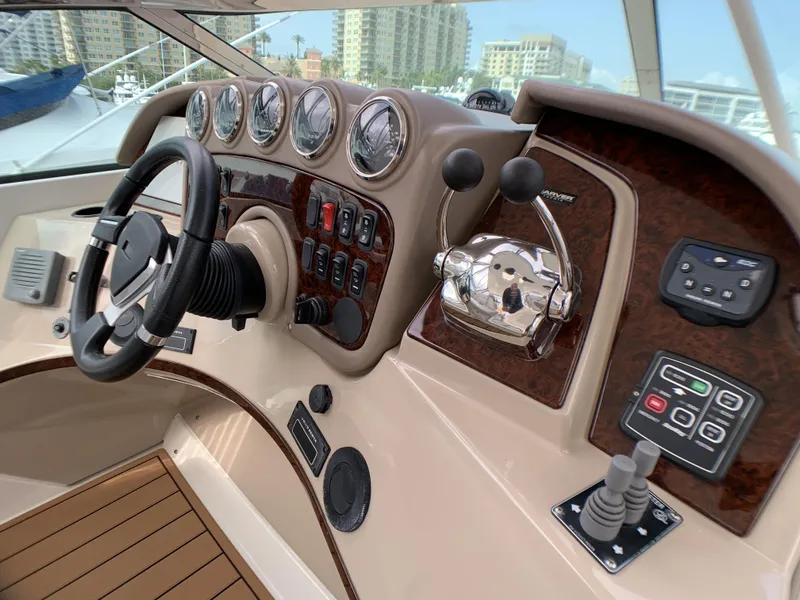 Slide: The Image of 2006 Carver 56 Voyager yacht helm with steering wheel, gauges, and control panels. - 5