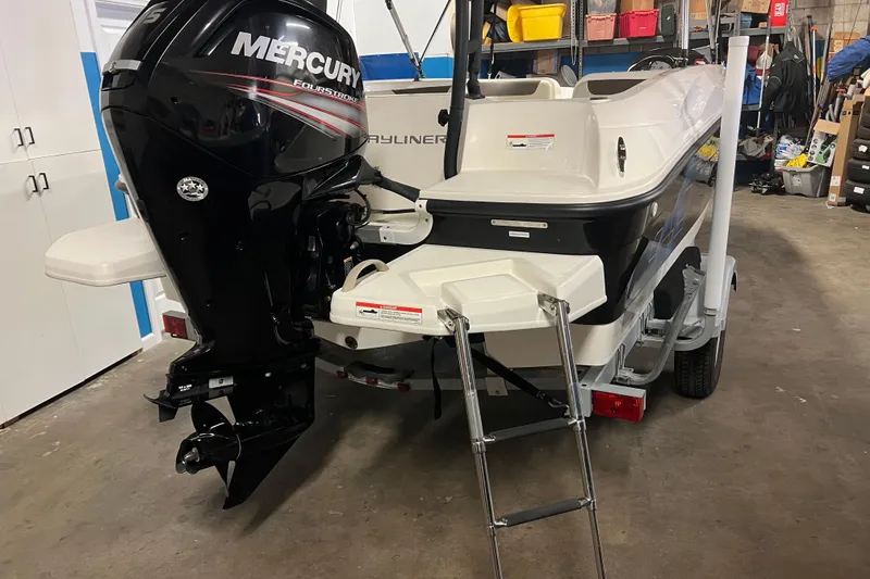 Slide: The Image of 2019 Bayliner Element E18 boat with Mercury FourStroke engine in a garage. - 3