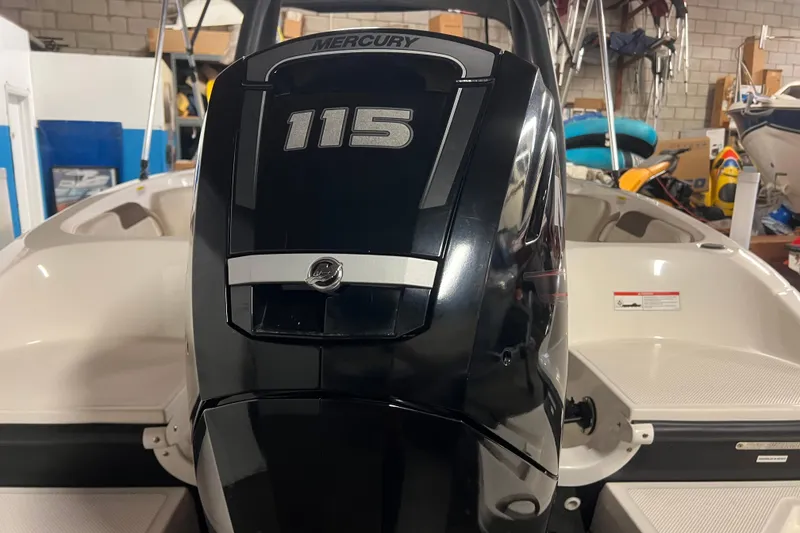 Slide: The Image of 2019 Bayliner Element E18 with Mercury 115 outboard engine in a garage setting. - 4