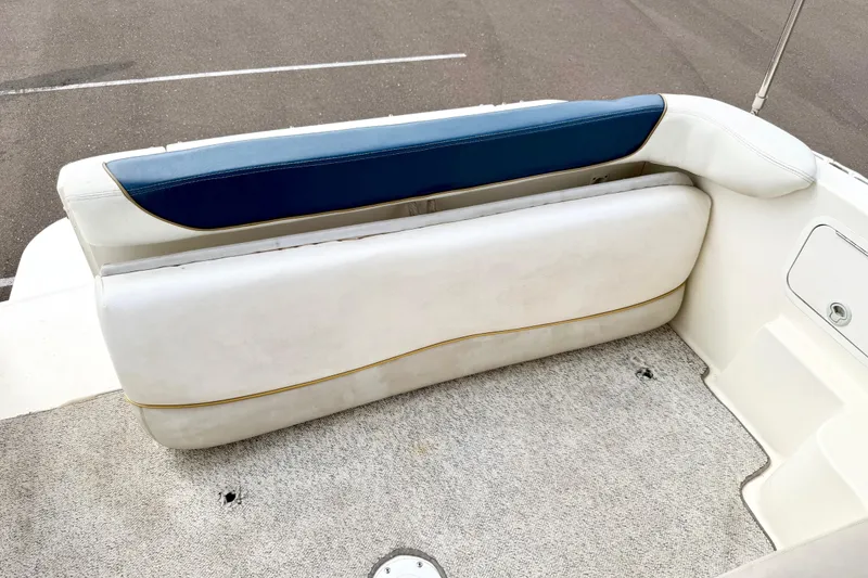 Slide: The Image of 1999 Sea Ray Sundancer 260 boat seating area with white and blue upholstery. - 11