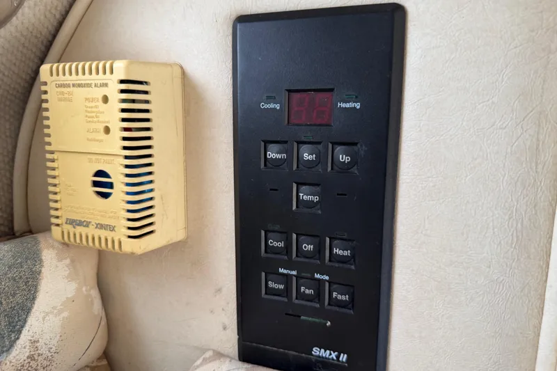 Slide: The Image of Control panel and carbon monoxide alarm on 1999 Sea Ray Sundancer 260 boat interior. - 22
