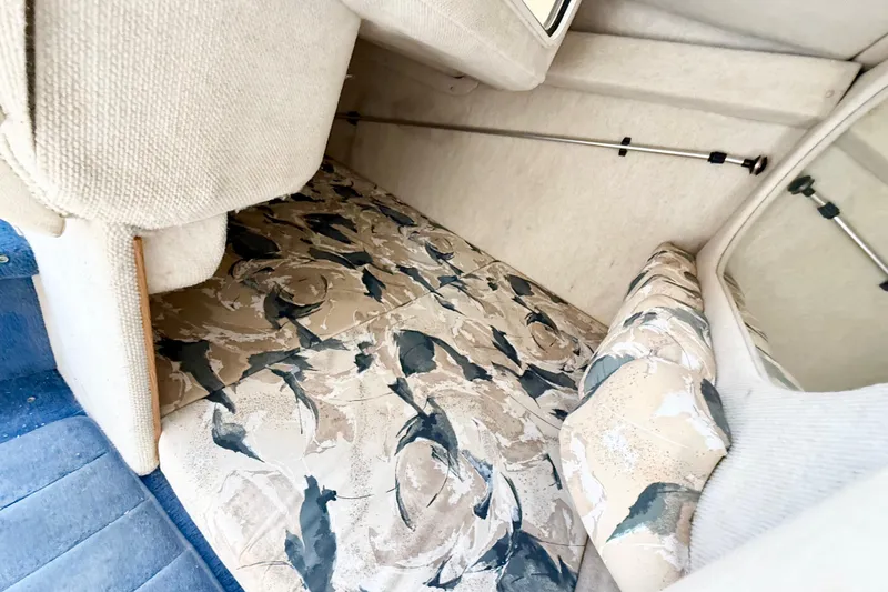 Slide: The Image of Interior cabin of 1999 Sea Ray Sundancer 260 with patterned upholstery and cozy seating. - 25