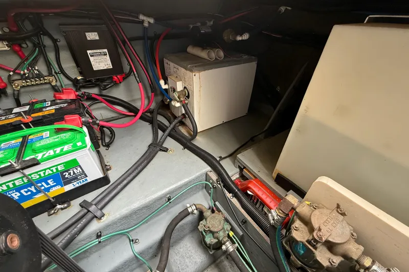 Slide: The Image of 1999 Sea Ray Sundancer 260 engine compartment with batteries and wiring. - 28