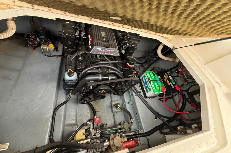 Slide: The Image of Engine compartment of a 1999 Sea Ray Sundancer 260 with visible battery and wiring. - 30