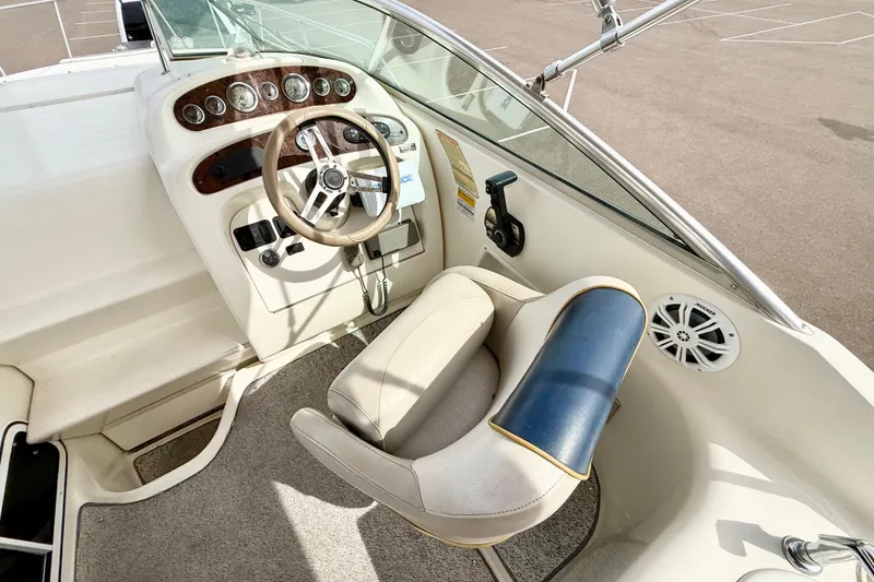 Slide: The Image of 1999 Sea Ray Sundancer 260 helm with steering wheel, gauges, and captain's chair. - 5
