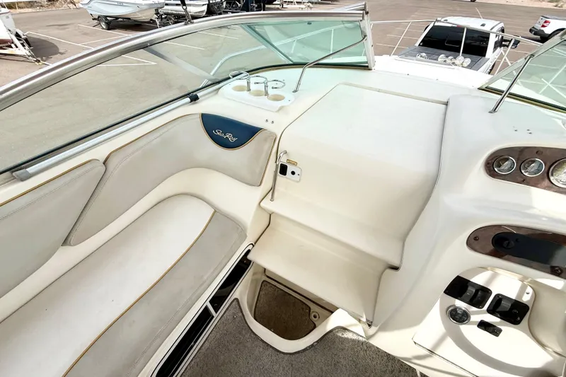 Slide: The Image of 1999 Sea Ray Sundancer 260 boat interior with seating and dashboard view. - 6
