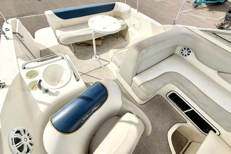 Slide: The Image of 1999 Sea Ray Sundancer 260 boat interior with seating, table, and sink. - 8