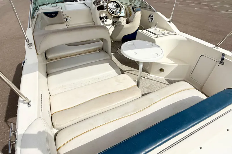 Slide: The Image of 1999 Sea Ray Sundancer 260 boat interior with seating and steering wheel. - 9