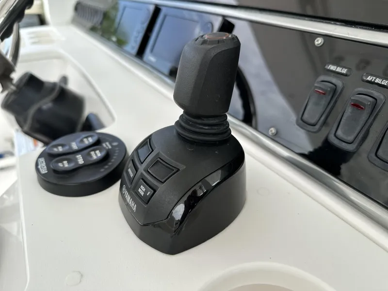 Slide: The Image of Control panel of 2017 Everglades 435 Center Console boat with joystick and switches. - 34