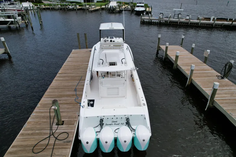 Slide: The Image of 2017 Everglades 435 Center Console boat docked at a marina. - 7