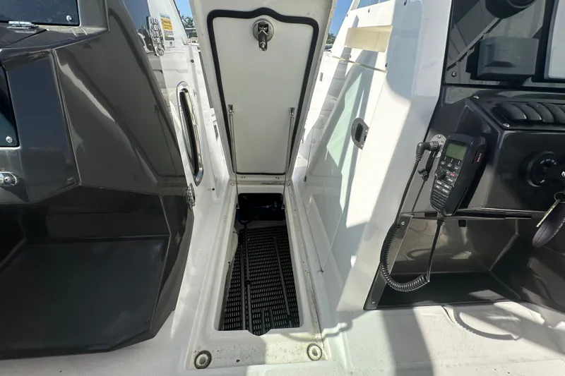 The Image of 2021 Blackfin 252 DC boat interior showing storage compartment and control panel. - 1