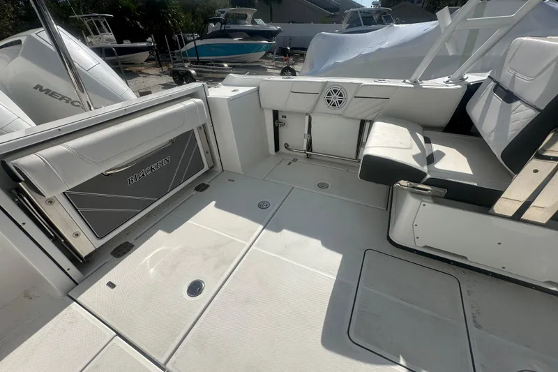 Slide: The Image of 2021 Blackfin 252 DC boat interior with seating and storage compartments. - 11