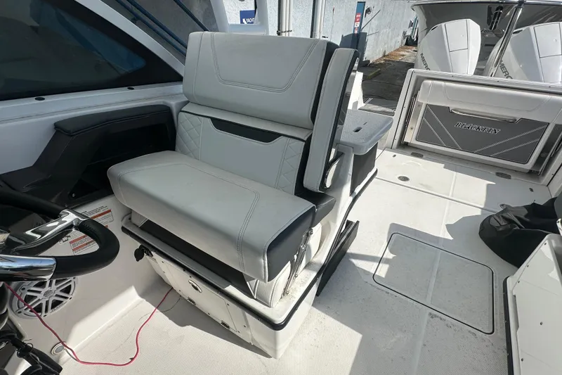 Slide: The Image of 2021 Blackfin 252 DC boat interior with seating and steering wheel. - 15