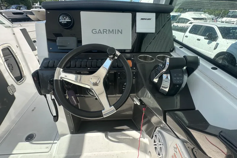 Slide: The Image of 2021 Blackfin 252 DC boat helm with Garmin navigation and Mercury controls. - 16