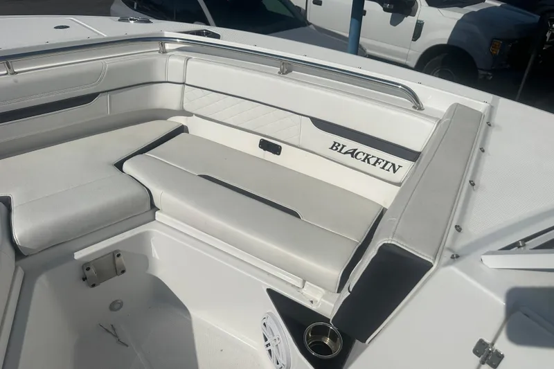 Slide: The Image of 2021 Blackfin 252 DC boat interior with white cushioned seating and sleek design. - 19