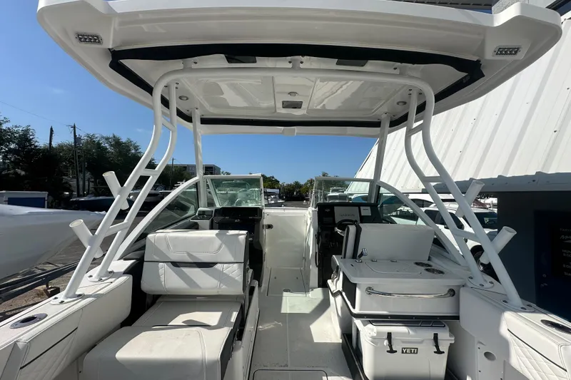 Slide: The Image of 2021 Blackfin 252 DC boat interior with seating and equipment under a clear blue sky. - 20